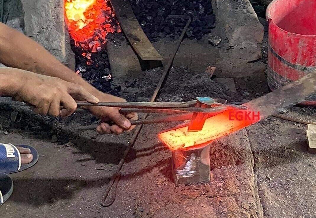 Cutting hot steel plate to forge a kukri.